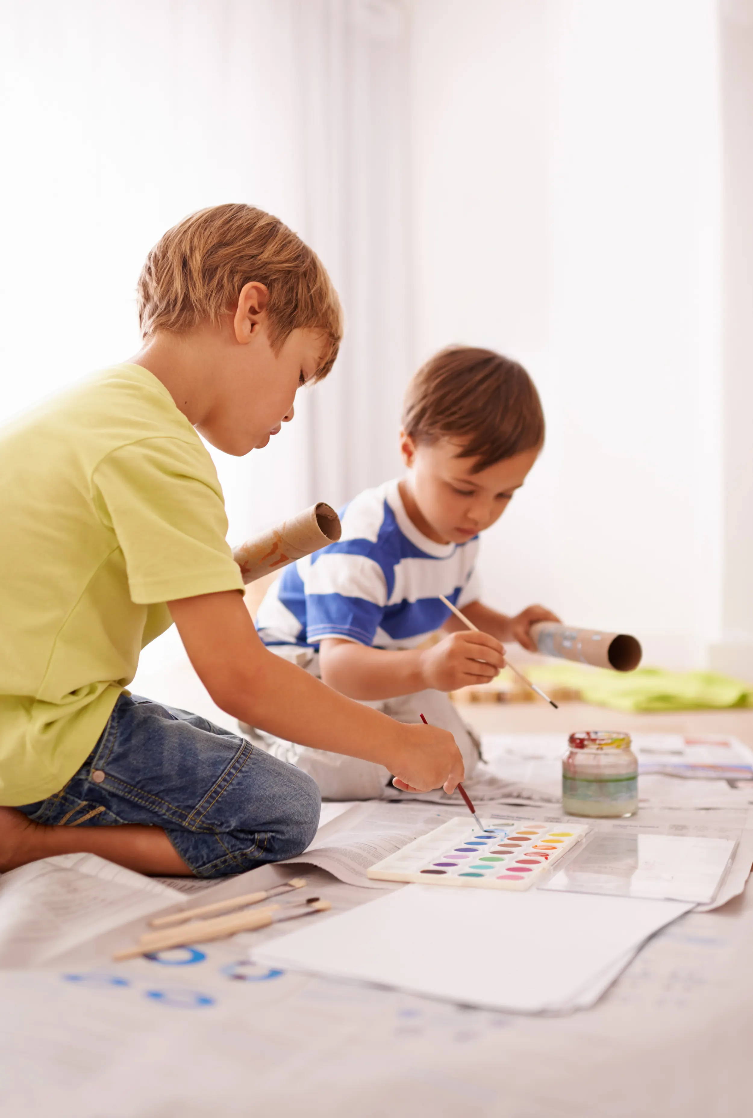 Children painting together in a home learning activity