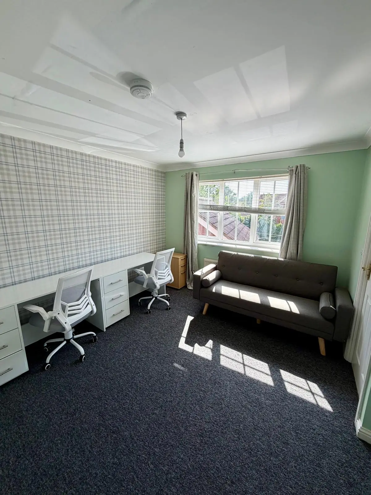 Study room with desks, sofa and window